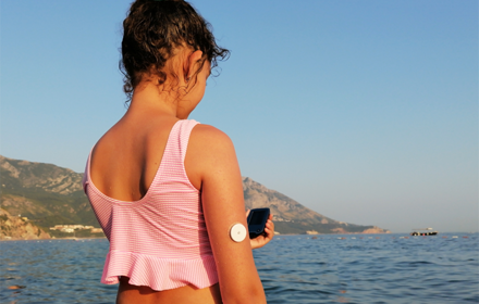 Girl With CGM On Arm Sea R